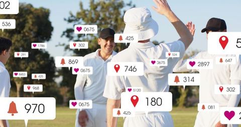 Cricket teammates high-fiving on field celebrating victory with social media notifications