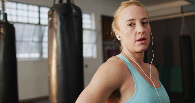 Focused Woman Taking Break During Intense Boxing Workout Session - Download Free Stock Images Pikwizard.com