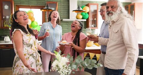 Senior Friends Celebrating Birthday with Joyful Laughter