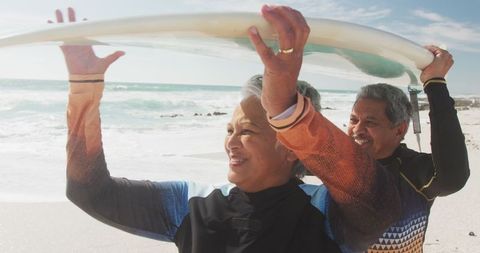Senior Couple Enjoying Beach with Surfboard - Download Free Stock Images Pikwizard.com