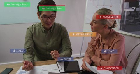 Colleagues discussing marketing data at meeting desk with social media alerts overlay