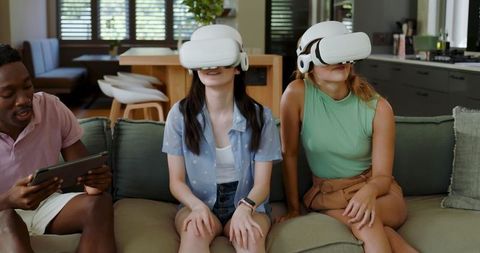 Group of Friends Using Virtual Reality Headsets in Modern Living Room