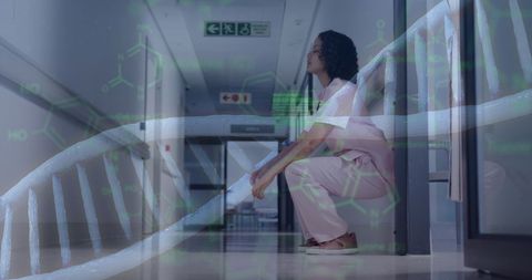 Combination of a tired female doctor sitting in a hospital corridor with a digital overlay of a DNA strand and molecular data. Highlights themes of healthcare professionals facing challenges, the integration of technology in medical environments, and advancements in research and data analysis. Suitable for illustrating modern medical themes, digital healthcare systems, science and molecular medicine, healthcare pressures, and biotechnology advancements.