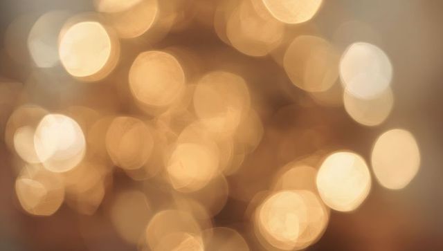 Warm Golden Bokeh Lights Abstract Background Showing Aperture Facets and Soft Glow