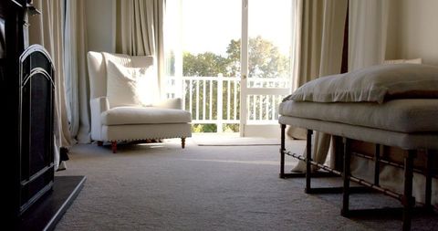 Cozy Sunlit Living Room with Armchair and Fireplace - Download Free Stock Images Pikwizard.com