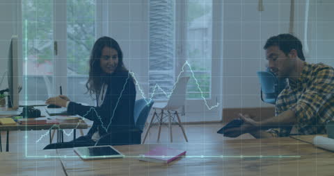 Coworkers Analyzing Data on Tablet with Graph Overlay