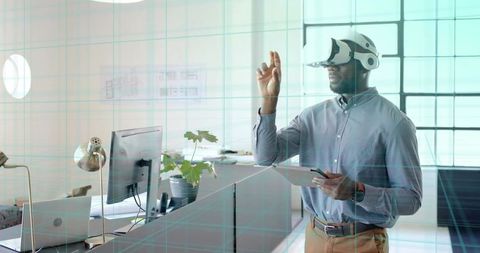 Man in Office Interacting with Virtual Reality Wearing VR Headset