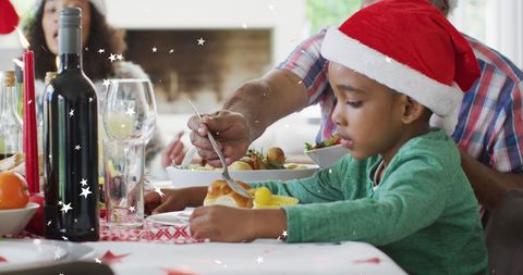 African American Boy Enjoying Christmas Meal with Family