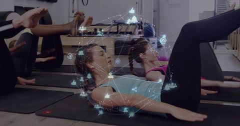 Women doing pilates core workout with augmented reality network overlay in reformer studio
