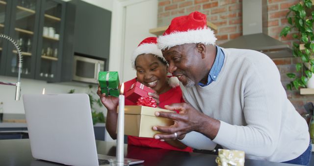 Happy Grandfather And Granddaughter in Santa Hats Video Calling Family on Laptop - Download Free Stock Images Pikwizard.com