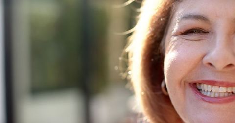 Close-Up of Senior Woman Smiling in Warm Sunlight