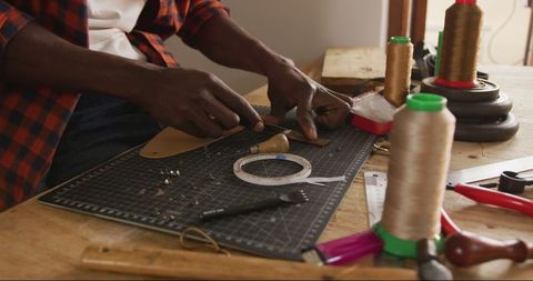 Craftsman artisan skillfully working with leather in workshop
