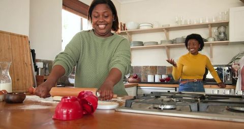 Two African American Women Baking Together in Bright Home Kitchen
