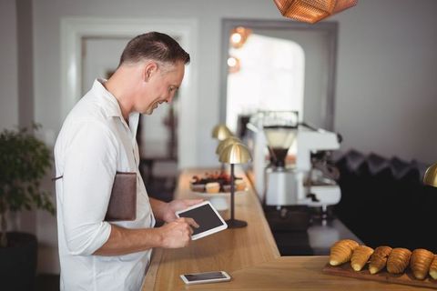 Businessman Cafetapping Tablet Near Freshly Baked Croissants