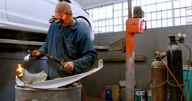 Mechanic Repairing Car Part with Welding Torch in Garage Workshop - Download Free Stock Images Pikwizard.com