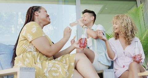 Diverse Group Relaxing and Laughing Together in a Cozy Living Room