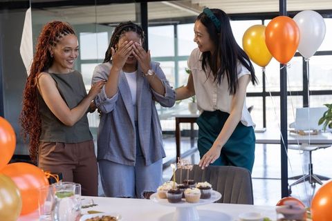 Office Celebration of Diverse Coworkers with Festive Balloons and Cupcakes