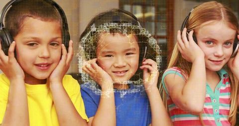 Three children listening with headphones in bright classroom with cracked-glass texture