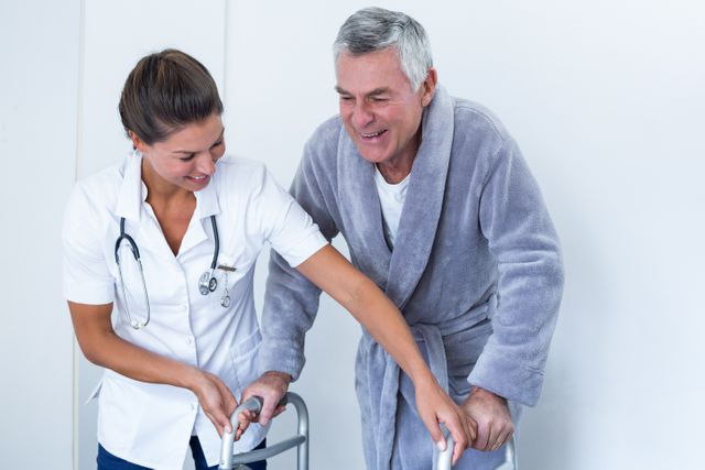 Female doctor helping senior man to walk with walker - Download Free Stock Photos Pikwizard.com