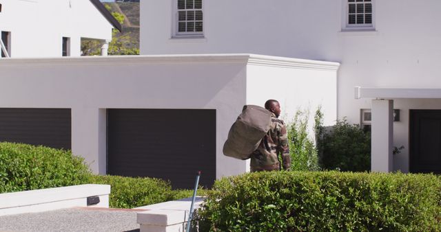 African american male soldier holding bag and going back home. Spending quality time at home.