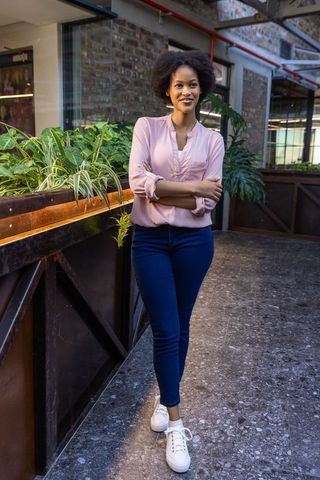 Confident Professional Woman in Modern Office with Green Decor