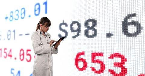 Female doctor analyzing trends on digital financial screen