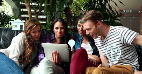 Young Professionals Collaborating on Tablet with Financial Data Overlays