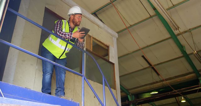 Engineer Wearing Safety Gear Inspecting Manufacturing Facility - Download Free Stock Images Pikwizard.com