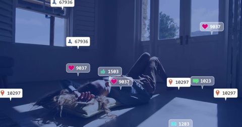 Young woman lying on floor scrolling smartphone with social media notifications, sunbeams