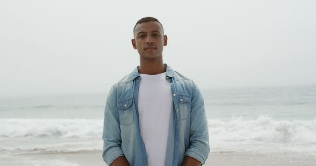 Confident Young Man Standing on Beach by Ocean - Download Free Stock Images Pikwizard.com