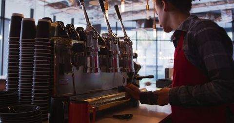 Barista Cleaning Coffee Machine in Urban Cafe
