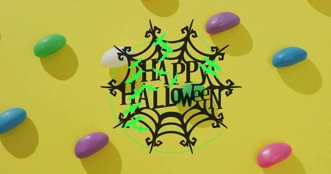 Bright halloween flatlay with spiderweb happy halloween graphic, neon bats and jellybeans