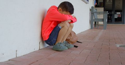 Sad Schoolboy Sitting Alone with Head Down - Download Free Stock Images Pikwizard.com