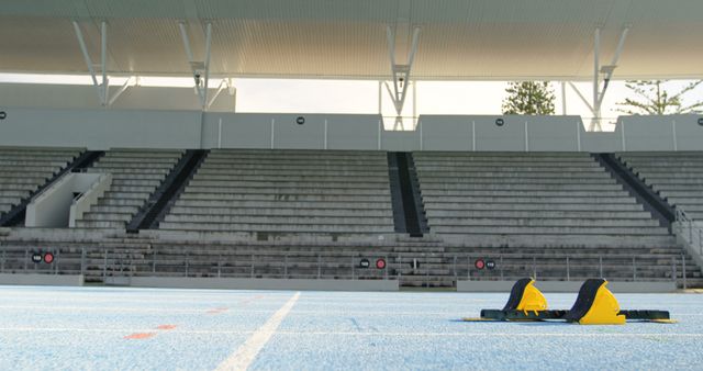 Starting Blocks on Blue Track in Empty Stadium - Download Free Stock Images Pikwizard.com