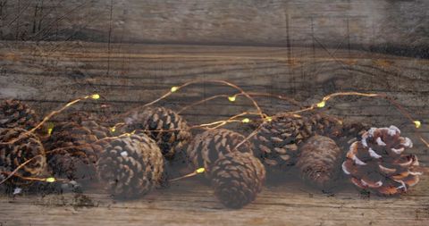 Pine Cones with Festive Lights on Rustic Wooden Surface - Download Free Stock Images Pikwizard.com