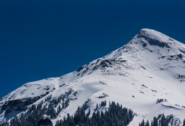 Snow-Capped Mountain Peak Against Clear Blue Sky - Download Free Stock Photos Pikwizard.com