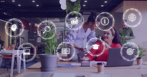Diverse team collaborating with digital business icons overlay