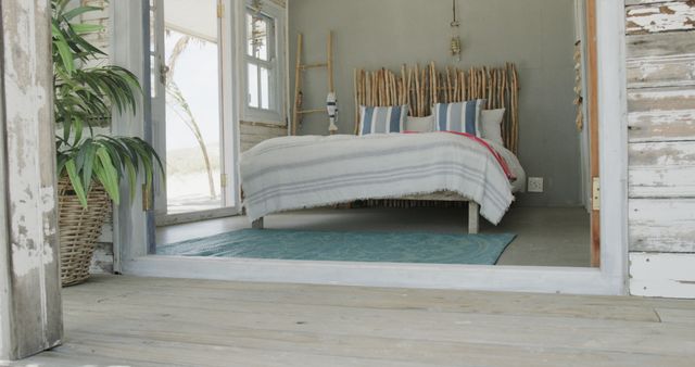 Empty room of beach house with wooden decorations and big bed. Interior, nature, vacation, summer and leisure.
