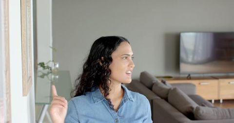 Woman Pointing at Art in Modern Minimalistic Living Room