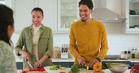 Friends Preparing Meal Together in Modern Home Kitchen