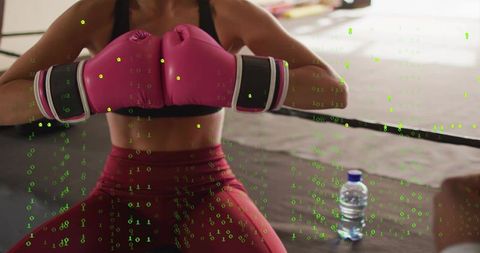 Boxer pressing pink gloves at ring edge with neon binary code overlay