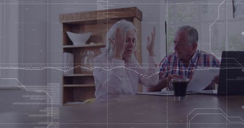 Frustrated couple discuss digital finance data at home table