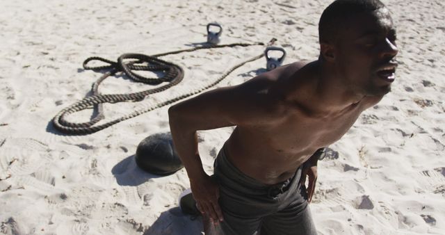 Tired Man Resting After Intense Beach Workout with Battle Ropes - Download Free Stock Images Pikwizard.com