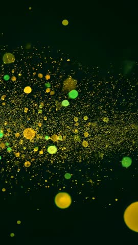 Vertical particle burst forming glowing green and gold orb cloud across dark backdrop