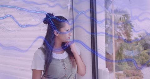 Thoughtful Woman by Window with Digital Waveform Overlay