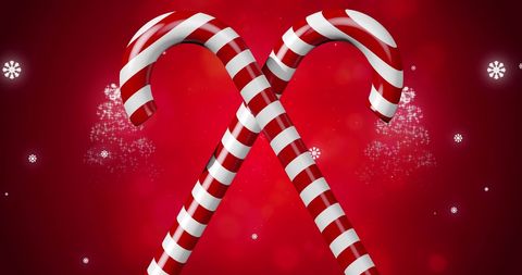 Festive Candy Canes and Snowflakes Over Red Background