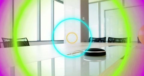 Conference room speaker puck reflecting on glossy table with neon circular light overlay