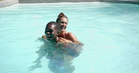 Diverse Couple Enjoying a Refreshing Summer Swim in Pool - Download Free Stock Images Pikwizard.com