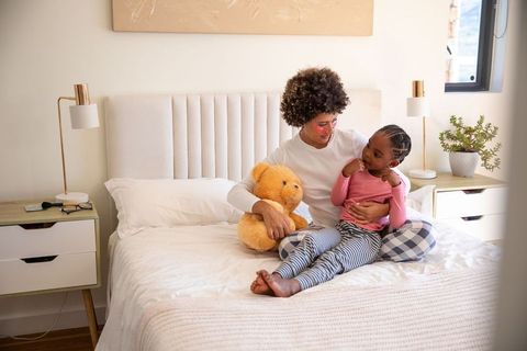 Family Bonding: Mother and Daughter in Cozy Bedroom Setting