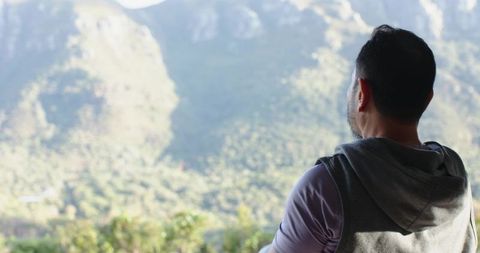 Man Gazing at Mountain Valley from Terrace in Natural Serenity